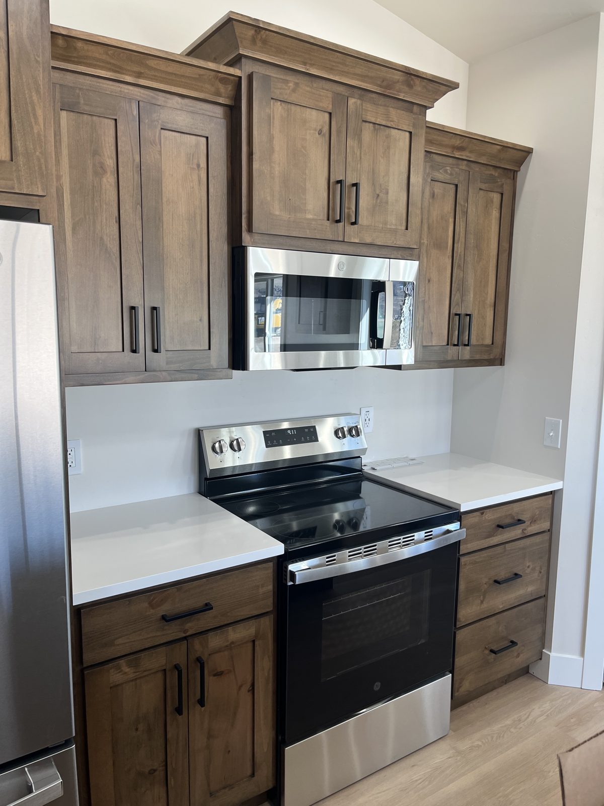 Walnut cabinets and stainless range in the Summit home kitchen