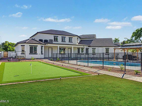 Backyard with putting green and pool at the Quartz estate