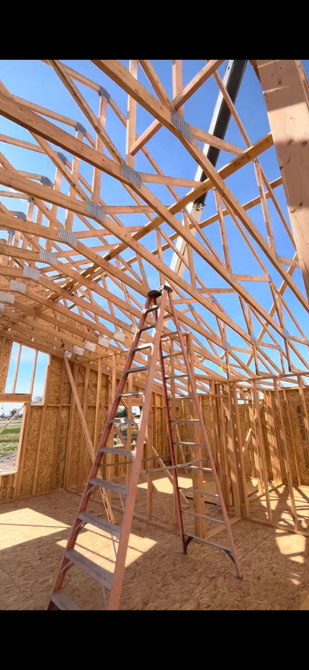Roof trusses going up on a Western Legacy Homes build