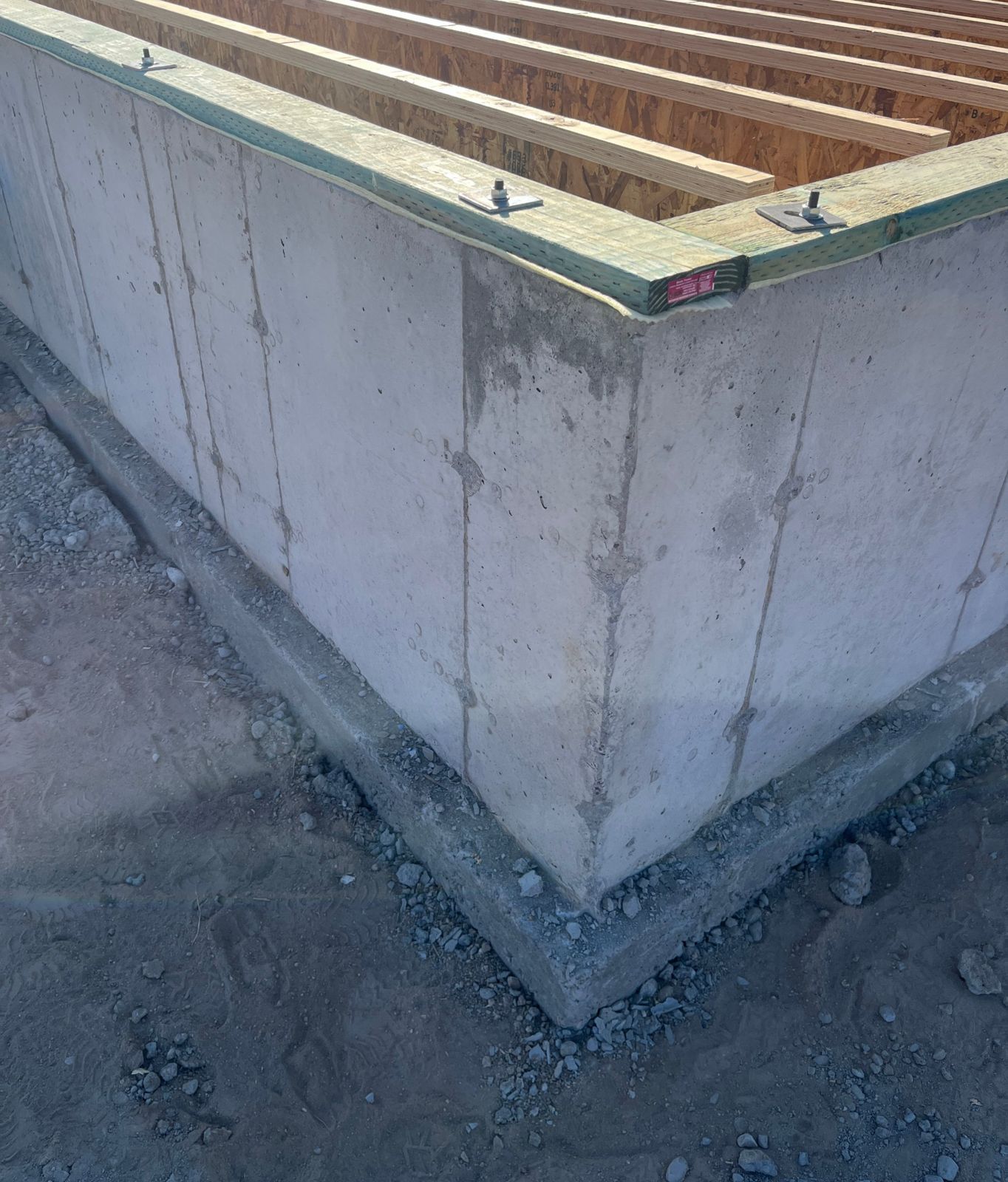 Finished foundation wall with floor joists set on top