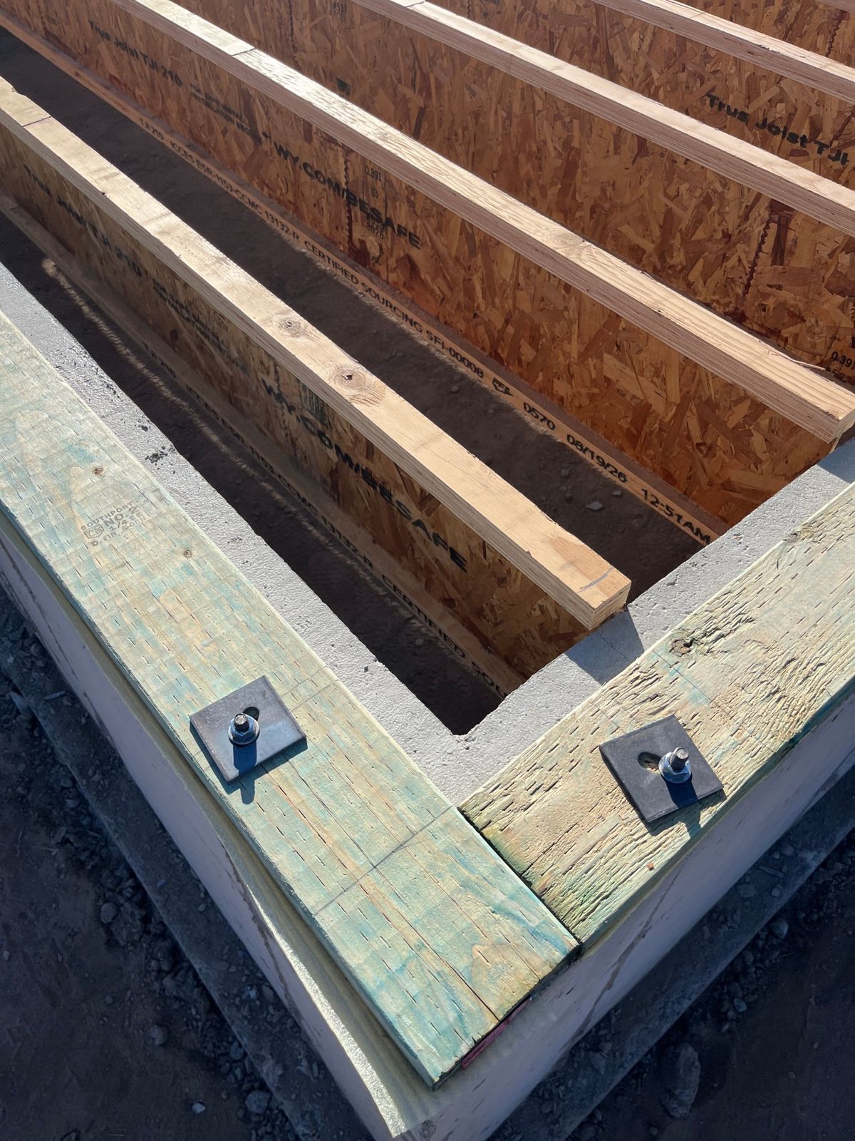 Sill plate anchored to the foundation with engineered floor joists