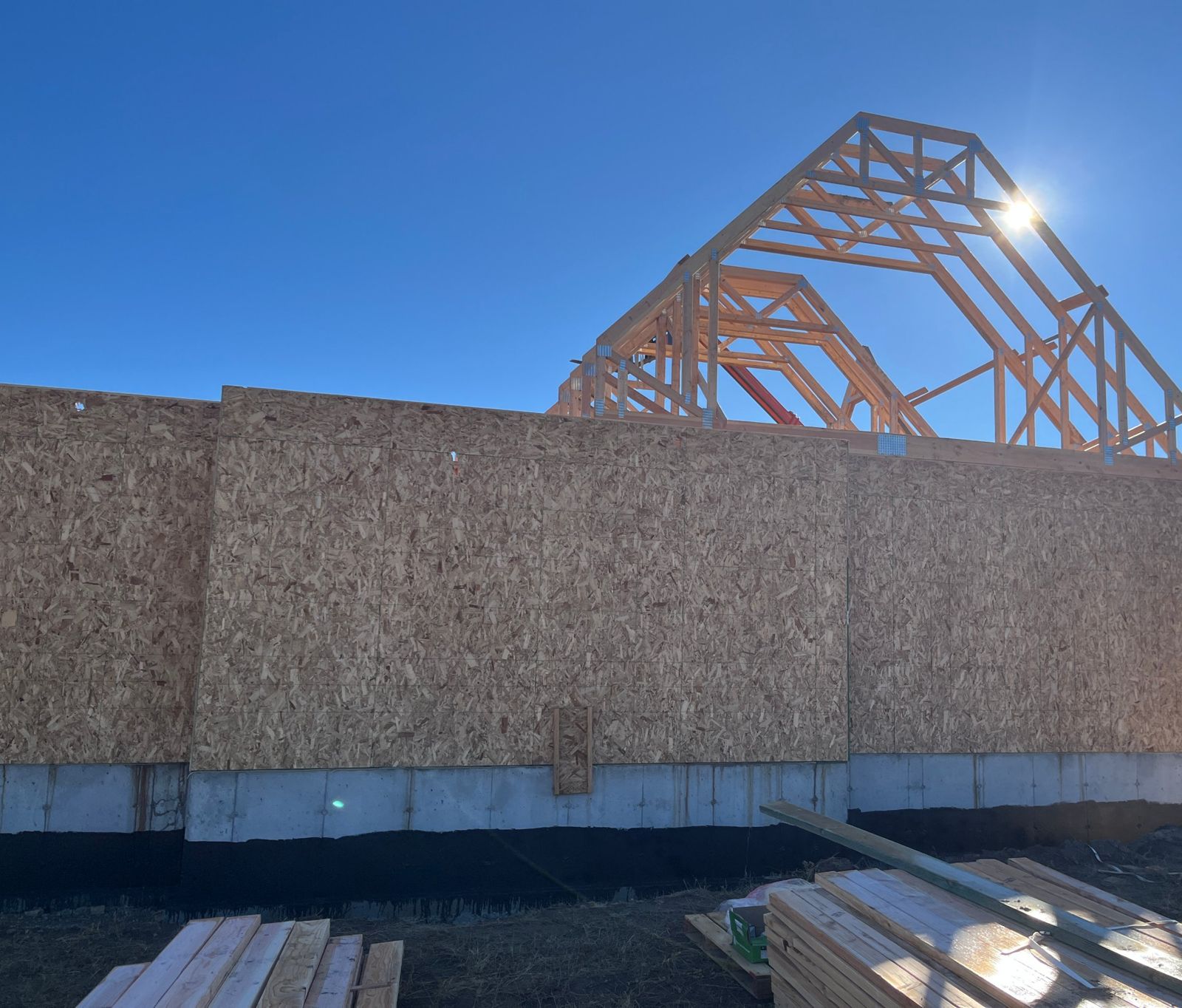 Sheathed walls with roof trusses going up