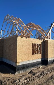 Framed and sheathed home with roof trusses in place