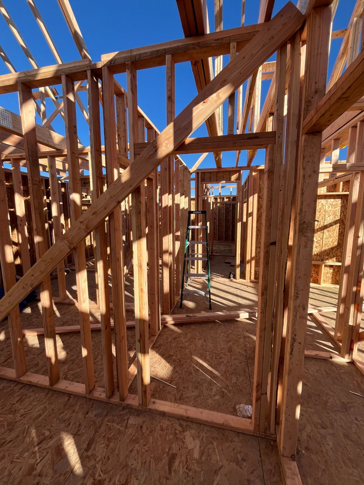 Interior wall framing looking down a hallway